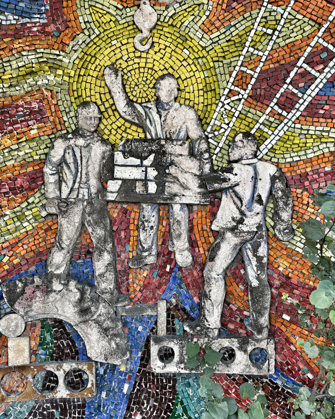 Colorful Soviet-era mosaic depicting workers and industrial themes in Nasimi district, Baku