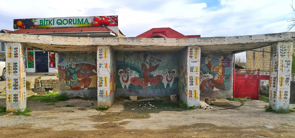 Colorful mosaic bus stop in Guba, Azerbaijan, decorated with shepherding motifs.